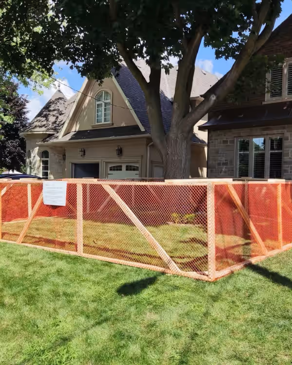 Orange tree protection fencing installed at a construction site